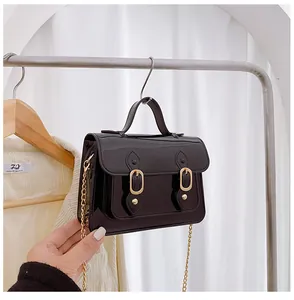 Elegant black glossy Cambridge jelly bag with gold chain strap and top handle detail.