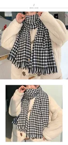 Model wearing a classic black and white houndstooth thick cashmere-like winter scarf