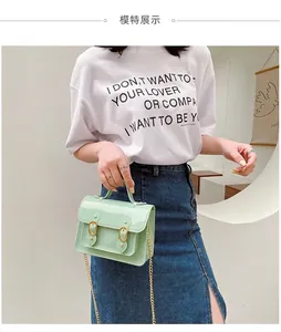 Detailed view of a stylish mint green jelly Cambridge bag featuring a gold chain strap