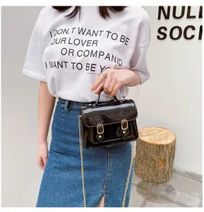 Glossy black jelly Cambridge bag with magnetic buckle and gold chain strap detail