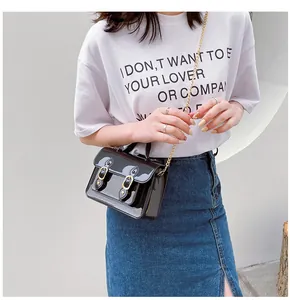 Stylish black jelly Cambridge crossbody bag with gold chain strap on model for summer