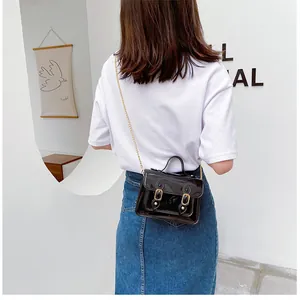 Rear view of a stylish model wearing a shiny black jelly Cambridge crossbody bag for summer