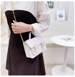 Stylish white jelly crossbody bag with gold chain strap shown on an Asian model.