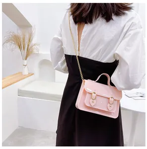 Stylish pink jelly crossbody bag with gold chain strap in a classic Cambridge design