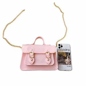 Detail of pink jelly mini Cambridge bag shown next to a smartphone for size comparison