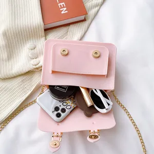 Pink summer jelly Cambridge crossbody bag with magnetic buckle showing interior storage
