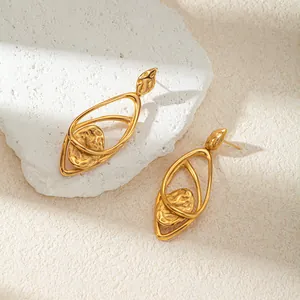 Close-up detail of gold textured geometric double-layer hollow stainless steel earrings