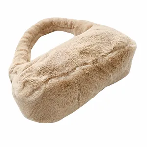 Detailed close-up of soft beige faux fur texture on the bottom of a plush shoulder bag.