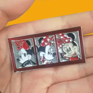 Close-up detail of a rectangular metal enamel pin featuring three Minnie Mouse poses