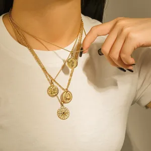 Multiple layered gold-plated stainless steel coin pendant necklaces worn by a model