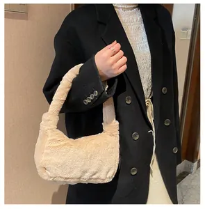 Plush beige faux fur underarm bag for women worn with a black blazer for winter style
