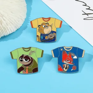 Three T-shirt shaped enamel pins featuring Zootopia movie characters on blue background