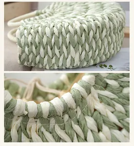 Detail shot showing the sage green and cream woven texture of a half-moon handbag.