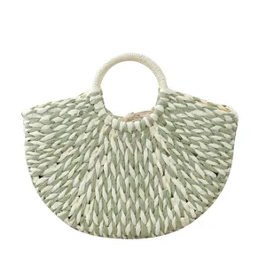 Handmade sage green and cream woven moon bag with round handles for summer fashion