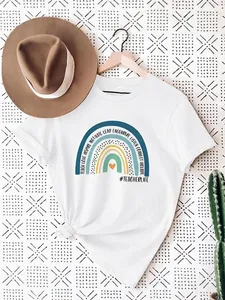 Detailed view of white teacher rainbow T-shirt with inspirational graphic design