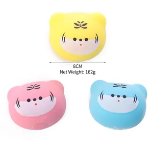 Set of three colorful tiger head squishy stress relief toys in yellow, pink and blue