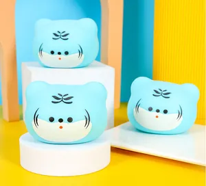 Close-up of three cute blue tiger squishy stress relief toys on white display blocks