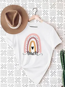Detailed view of creative boho rainbow and teach text print on a soft white cotton t-shirt