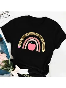 Detailed view of teacher-themed rainbow pencil and apple print on black t-shirt