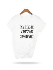 White graphic t-shirt for teachers featuring inspirational quote on wooden hanger