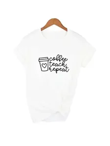 Close-up detail of white cotton T-shirt featuring 'coffee teach repeat' graphic print