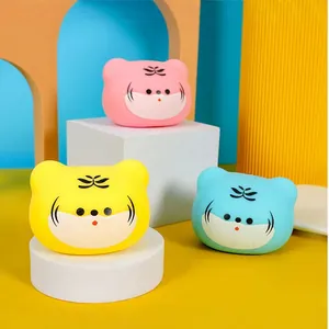 Set of three colorful tiger-shaped squishy stress relief toys on minimalist stands