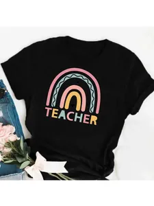 Close-up of a black cotton T-shirt featuring a colorful rainbow and Teacher print design.