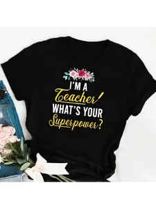 Detail view of a black women's T-shirt with 'I'M A Teacher' floral graphic print.