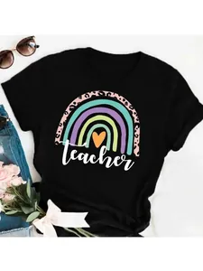Detail view of colorful rainbow and teacher text print on a black women's t-shirt
