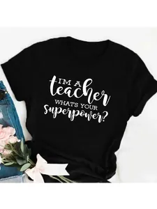 Close-up detail of 'I'M A teacher' white letter print on a black cotton T-shirt