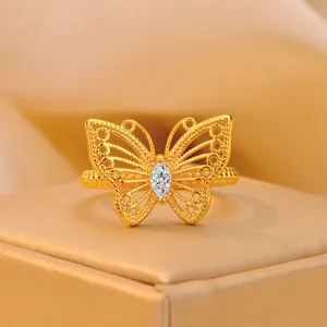 Elegant hollow 3D gold butterfly open ring with a sparkling marquise cut zircon stone.