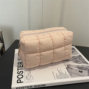 Stylish pink quilted puffy cosmetic bag featuring a cloud texture and grid stitching pattern