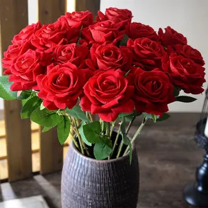 Elegant deep red velvet artificial roses in a rustic textured vase for home wedding decor
