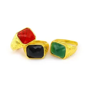 Vintage men's adjustable gold rings with red, black, and green faceted faux gemstones.