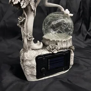 Close-up of solar panel and power switch on the base of garden fairy ornament