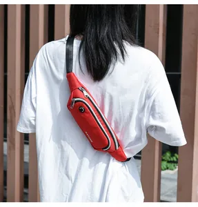 Detailed view of the red waterproof sports waist bag worn as a crossbody chest bag