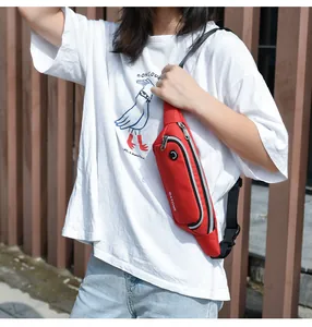 Detailed view of a red lightweight waterproof sports chest bag worn by a model outdoor