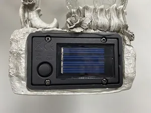 Close-up detail of the solar power control unit and switch on resin garden statue light