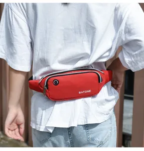 Detail view of red waterproof sports waist bag with headphone jack worn by person
