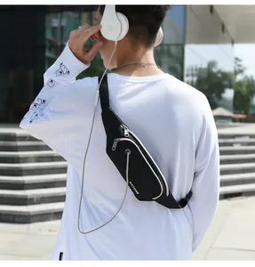 Close-up of lightweight waterproof black waist bag worn cross-body in outdoor scene