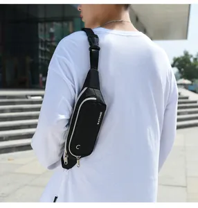 Male model wearing a slim black sports waist bag for running and outdoor fitness
