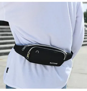 Close-up of a black waterproof sports waist bag with BATONE logo worn outdoors