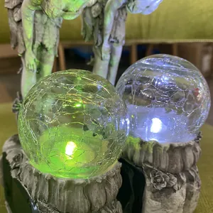 Solar powered glowing crackle glass ball garden statue with flower fairy resin base