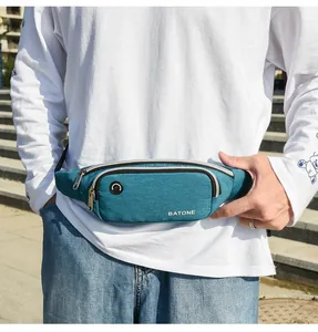 Close-up detail of a teal waterproof sports waist bag featuring a convenient headphone port