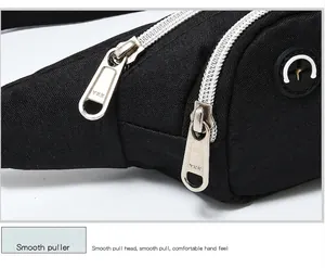 Close-up of smooth YKK zippers on a black waterproof sports waist bag detail.