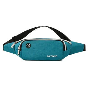 Slim blue sports waist bag for running with waterproof material and headphone jack hole.
