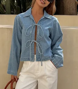 Detail of a stylish French-style tie-up denim jacket with bow front closures for women