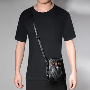 Punk style black owl-shaped mini crossbody bag worn by a model in a black T-shirt