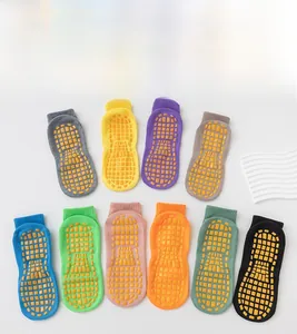 Variety of colorful anti-slip trampoline yoga socks with yellow rubber grippers on sole
