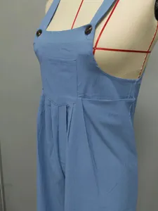 Detailed view of blue vintage casual overalls with button straps and pleated waist